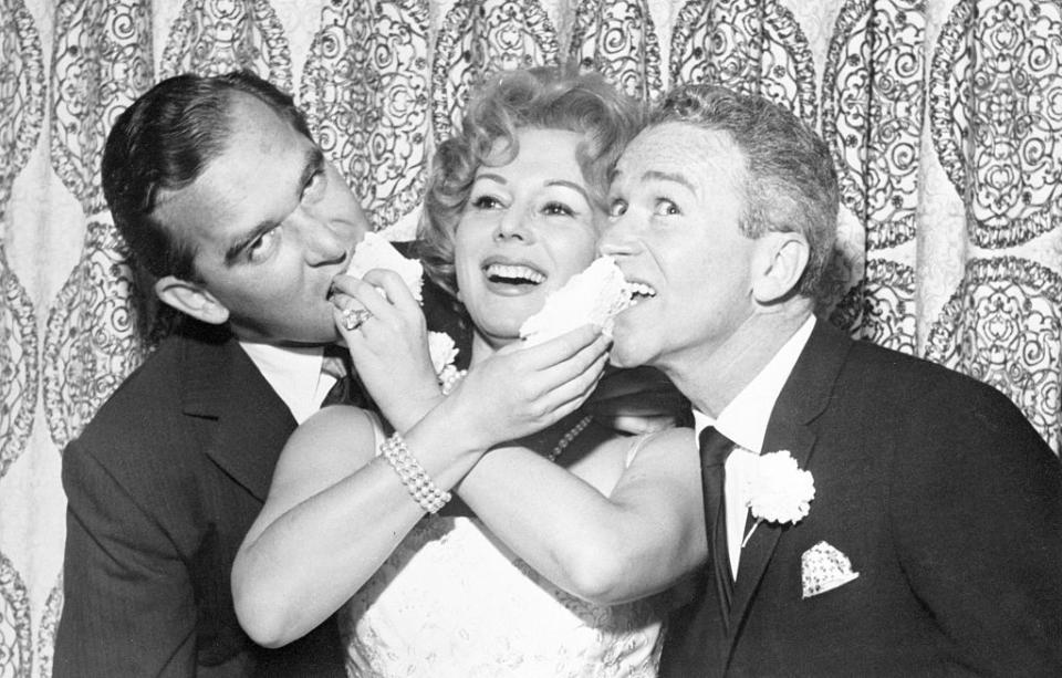 <p>Eva Gabor married her fourth husband, Richard Brown, at the Flamingo Hotel in Las Vegas. The actress was photographed feeding cake to her new husband (left) and his best man at the reception. </p>