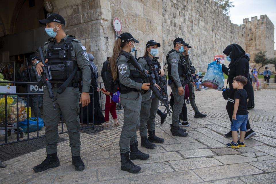 FILE - In this Oct. 29, 2020 file photo, Israeli border police officers check Palestinians identification cards as they make their way to the Al Aqsa Mosque compound to mark the birthday of the Prophet Mohammed, in Jerusalem's Old City. A dispute over Israeli restrictions on Palestinian voters in east Jerusalem is threatening to cancel or delay the first Palestinian elections in more than 15 years. President Mahmoud Abbas could use the issue as a pretext for avoiding an outcome that threatens his hold on power. (AP Photo/Oded Balilty, File)