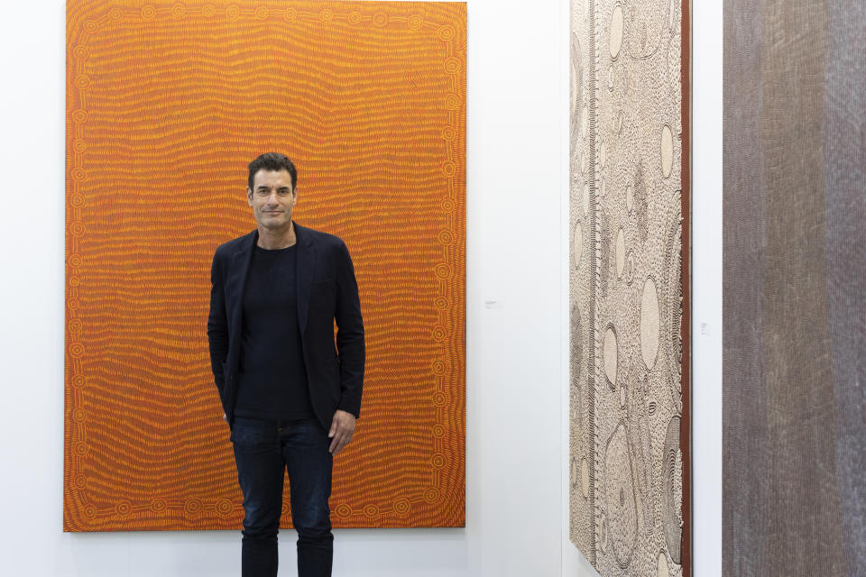 Art Money founder and CEO Paul Becker standing in an art gallery.