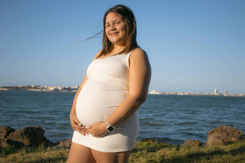 In this 2021 photo provided by Tanya B. Alves-Otero, her sister, Tamara Alves Rodriguez poses for a photo in San Juan, Puerto Rico. Seven months pregnant and unvaccinated, Rodriguez tested positive for the coronavirus Aug. 9. The young mother never held her child. Rodriguez died Oct. 30 at age 24. She left behind her husband, two other children and an extended family. (Layzné Alves-Otero via AP)