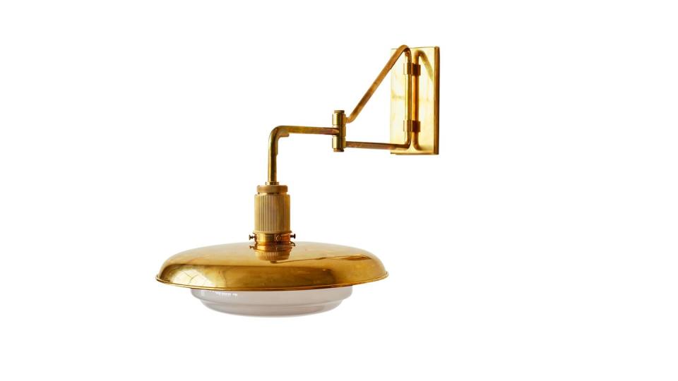 gold sconce with hinged arm and plate with white glass cover