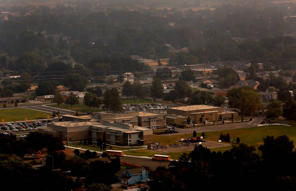 A layer of smoke from wildfires burning in the Pacific Northwest fills the air Monday morning as students arrive for classes at Fuerza Elementary School at 6011 W. 10th Pl. in Kennewick. Some Mid-Columbia school districts are cancelling student outdoor activities because of air quality concerns.