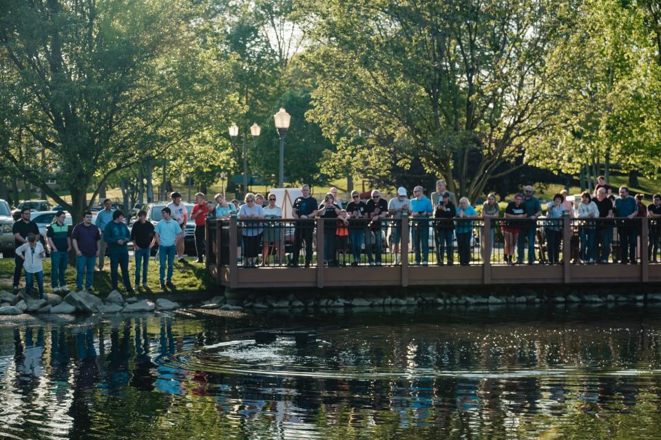 Onlookers observe the successful demonstration of the "Quality H2O" team's water skimmer earlier this month during a capstone presentation by engineering students from Kent State University at Tuscarawas at the Tuscora Park Pond in New Philadelphia.