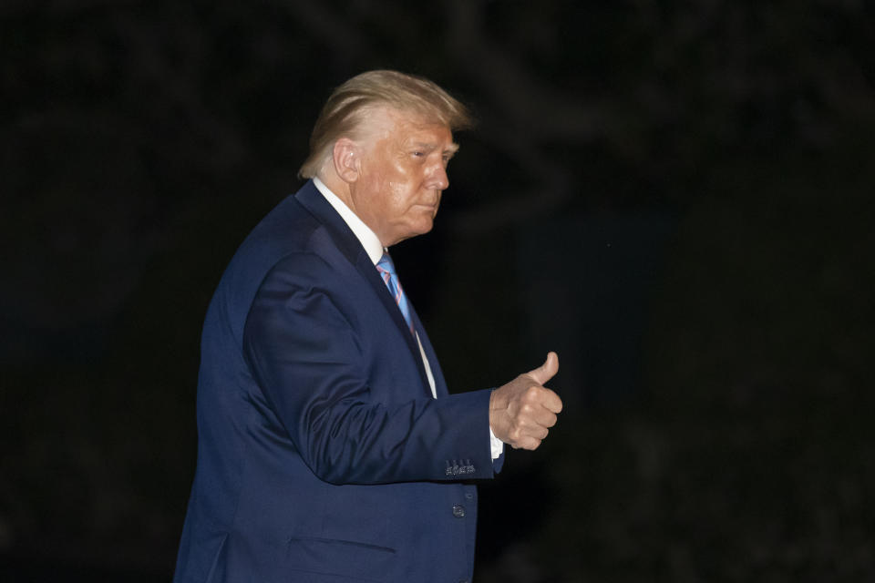 President Donald Trump gives a thumbs-up as he walks from Marine One as he returns to the White House from Texas, Wednesday, July 29, 2020, in Washington. (AP Photo/Alex Brandon)