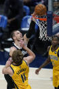 Los Angeles Clippers' Ivica Zubac (40) dunks over Indiana Pacers' Domantas Sabonis (11) during the first half of an NBA basketball game, Tuesday, April 13, 2021, in Indianapolis. (AP Photo/Darron Cummings)