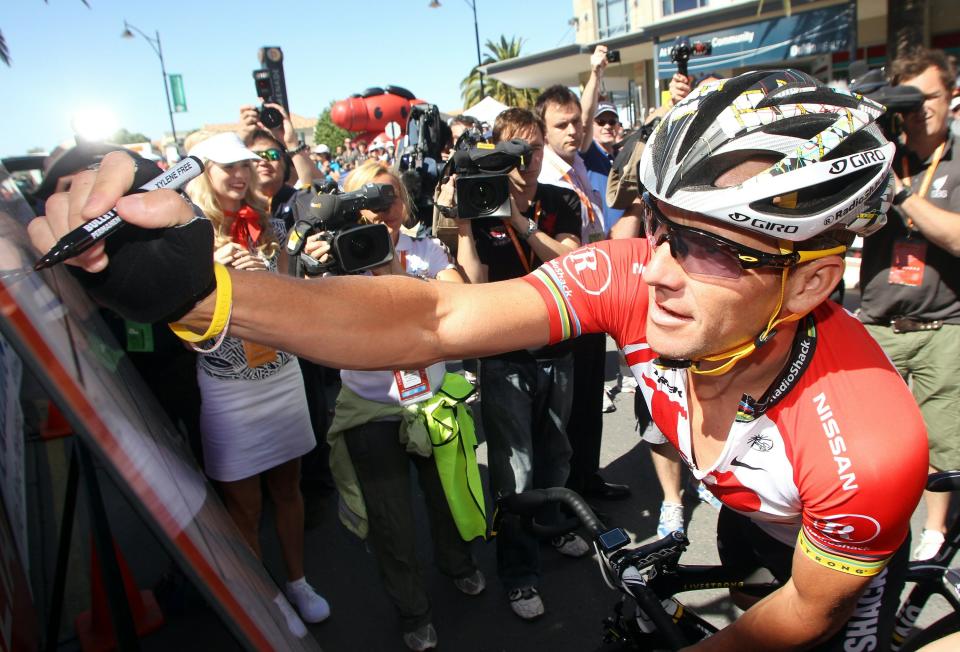 ADELAIDE, AUSTRALIA - JANUARY 18: Lance Armstrong of Team Radio Shack signs on before Stage One of the 2011 Tour Down Under on January 18, 2011 in Adelaide, Australia. (Photo by Morne de Klerk/Getty Images)