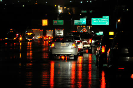 Stranded motorists wait out the storm on the Sidney Sherman Bridge after rainfall from Hurricane Harvey caused widespread flooding in Houston, Texas, U.S. August 27, 2017. REUTERS/Nick Oxford