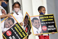 FILE - In this Aug. 28, 2020 file photo, family members of Ronald Greene listen to speakers as demonstrators gather for the March on Washington, in Washington, on the 57th anniversary of the Rev. Martin Luther King Jr.'s "I Have A Dream" speech. Federal prosecutors are investigating whether top Louisiana State Police brass obstructed justice to prevent troopers from being charged in the fatal 2019 arrest of Greene. (Michael M. Santiago/Pool via AP)