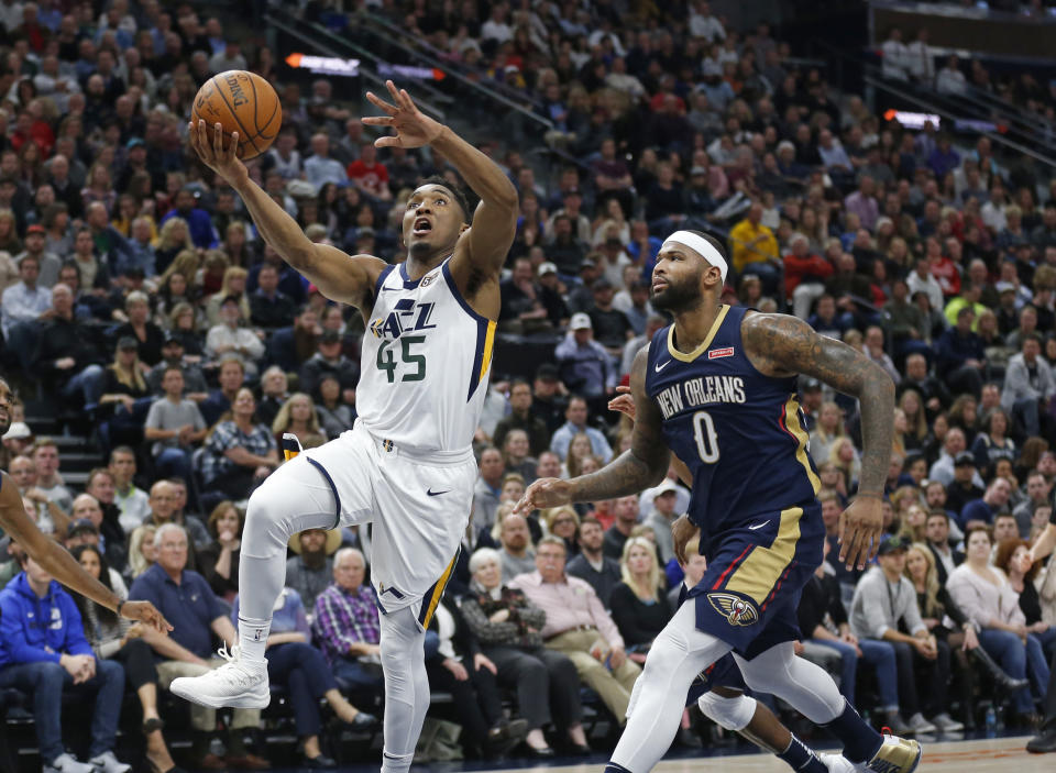 DeMarcus Cousins ponders his place in the cosmos as Donovan Mitchell leaves him behind to score two of his 40 points. (AP Photo/Rick Bowmer)