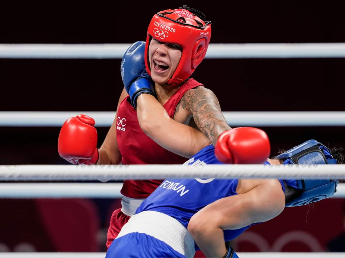 Canada's Tammara Thibeault, left, shown in this 2021 file photo, was victorious in her middleweight semifinal in Istanbul, on Wednesday. (Themba Hadebe/The Associated Press - image credit)