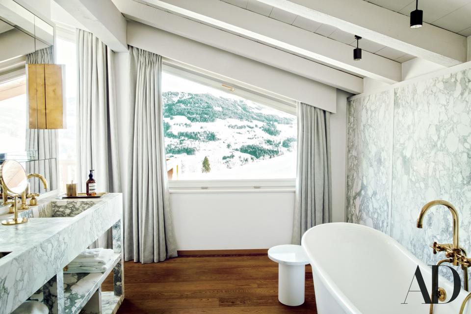 An E15 side table and The Water Monopoly tub in a Luis Laplace bathroom overlooking the French Alps.