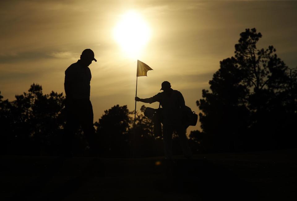 Rory McIlroy, of Northern Ireland, walks to the 17th green during the second round of the Masters golf tournament Friday, April 11, 2014, in Augusta, Ga. (AP Photo/Matt Slocum)