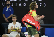 Greece's Stefanos Tsitsipas, right, walks past Russia's Daniil Medvedev as he leaves Rod Laver Arena after losing his semifinal at the Australian Open tennis championship in Melbourne, Australia, Friday, Feb. 19, 2021.(AP Photo/Andy Brownbill)