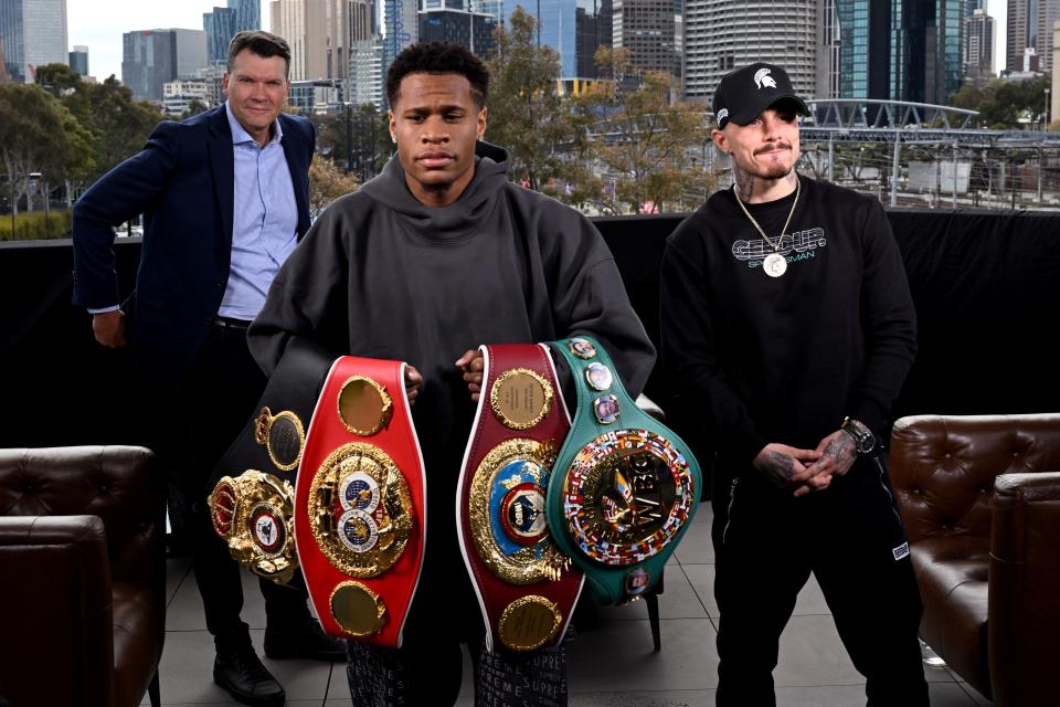 Devin Haney of the US (C) holds his title belts after a face-off with Australia's George Kambosos (R) in Melbourne on October 11, 2022, ahead of their rematch for the lightweight unification title to become the undisputed lightweight boxing champion of the world. - -- IMAGE RESTRICTED TO EDITORIAL USE - STRICTLY NO COMMERCIAL USE -- (Photo by William WEST / AFP) / -- IMAGE RESTRICTED TO EDITORIAL USE - STRICTLY NO COMMERCIAL USE -- (Photo by WILLIAM WEST/AFP via Getty Images)