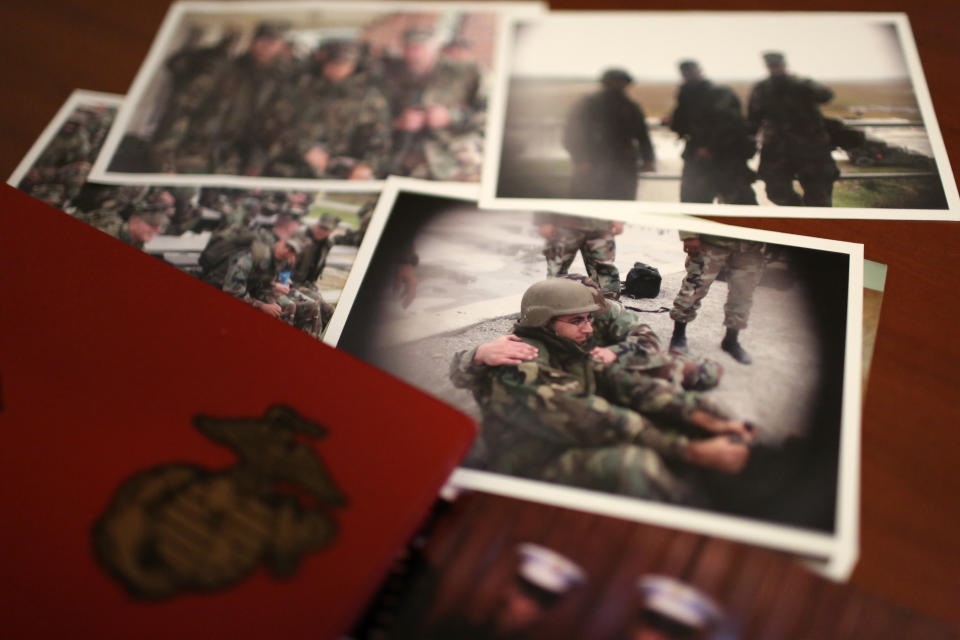 A group of old photos laying on Mansoor Shams' desk in his Baltimore home on Friday, Aug. 13, 2021, show him as a young Marine during his service from 2000-2004. After 9/11, Shams was called names like "Taliban," "terrorist" and "Osama bin Laden" by some of his fellow Marines. In recent years, Shams has used his identity as both a Muslim and a former Marine to dispel misconceptions about Islam. (AP Photo/Jessie Wardarski)