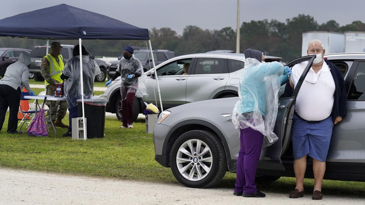 A man gets the coronavirus vaccine shot at an outdoor vaccination site at Lakewood Ranch on Wednesday, Feb. 17, 2021, in Bradenton, Fla.