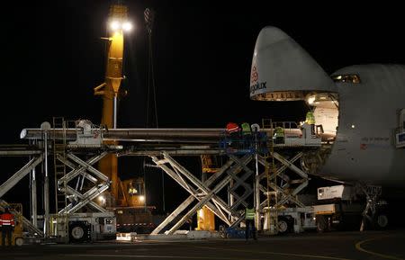 An element of a wing of the dismantled Solar Impulse 2 aircraft is loaded into a Cargolux Boeing 747 cargo aircraft at Payerne airport January 5, 2015. REUTERS/Denis Balibouse