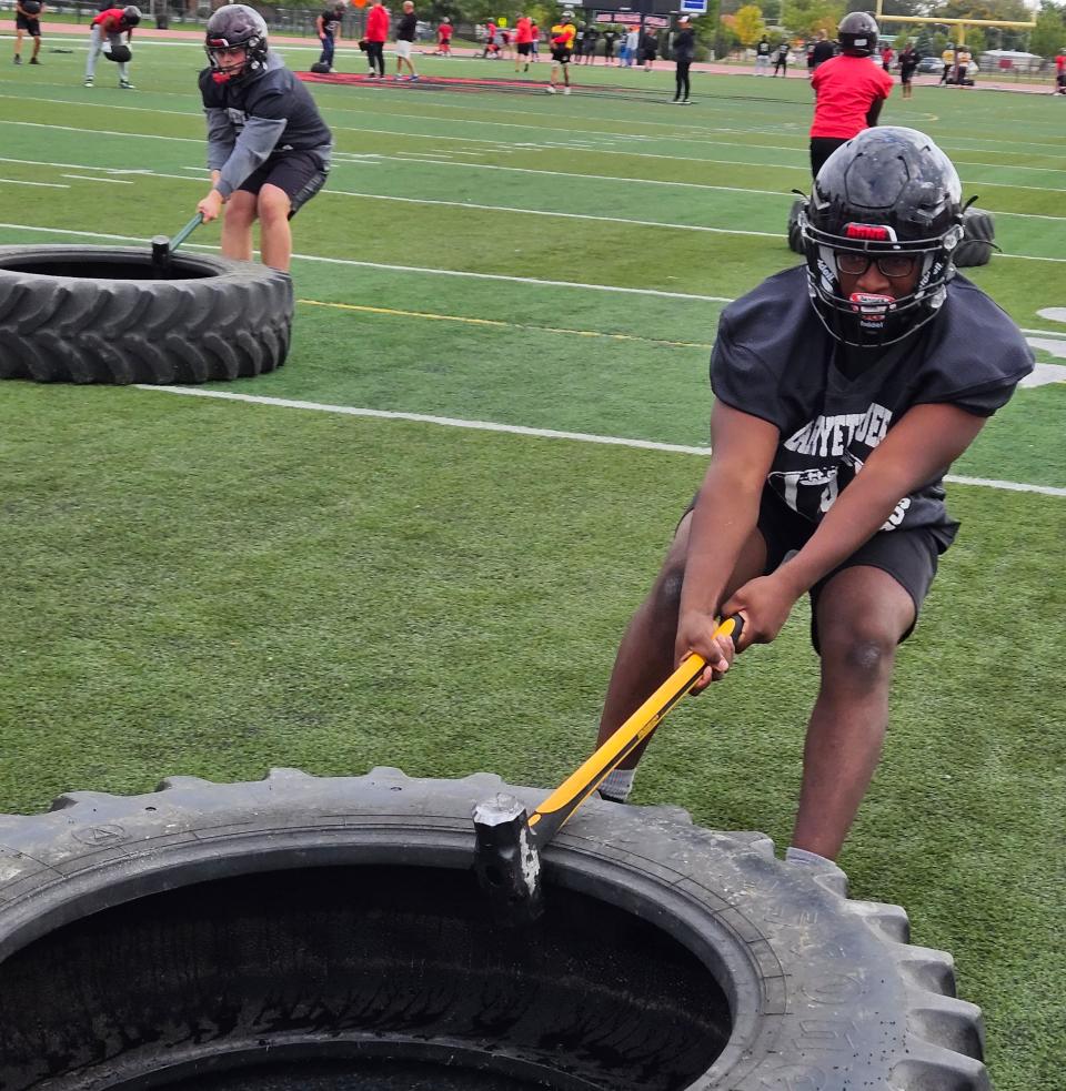 Lafayette Jeff senior Terrell Travis drags a tire using a 12-pound hammer during conditioning drills on Monday, Oct. 9, 2023.