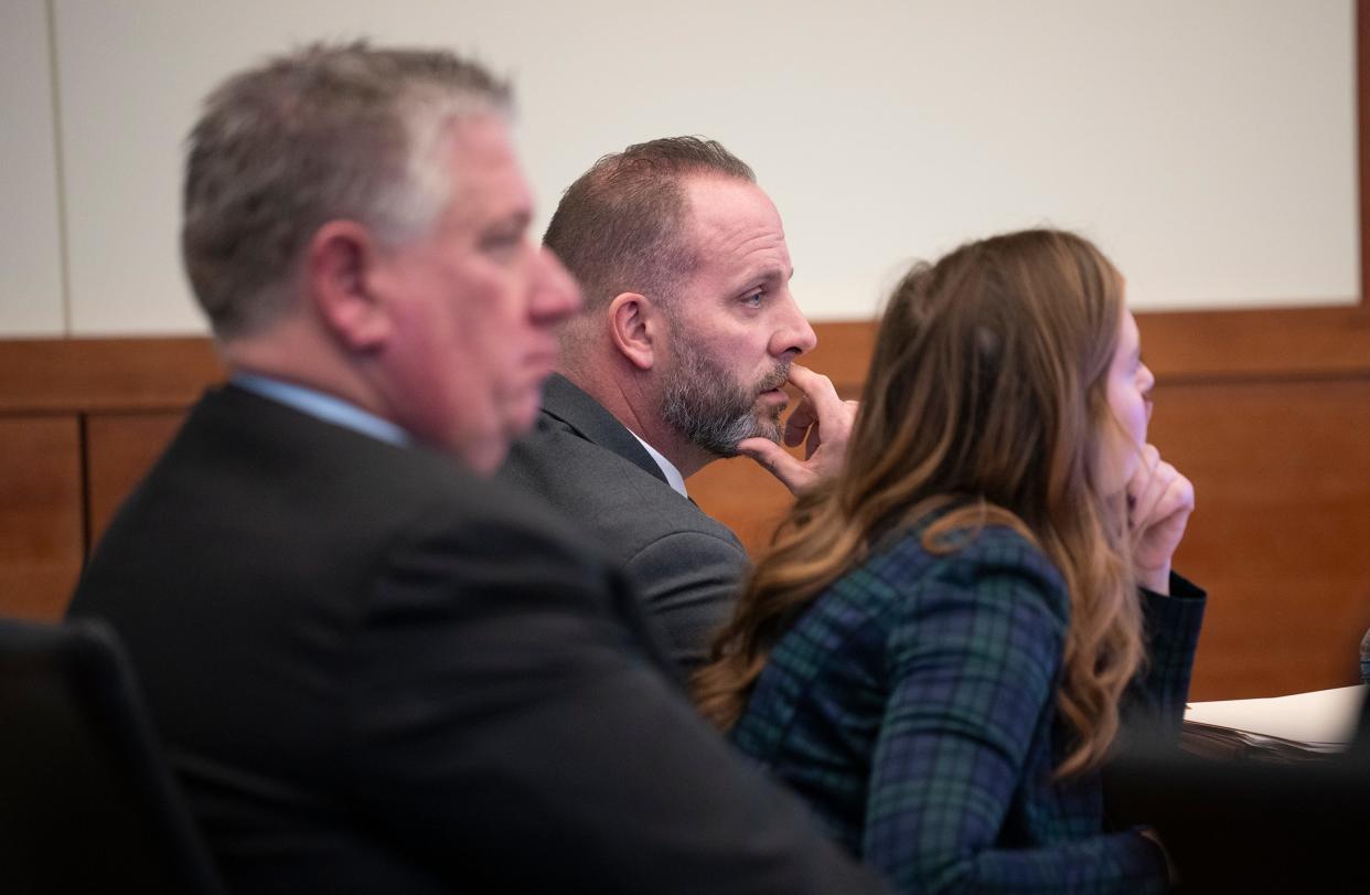 Former Franklin County Sheriff's office deputy Jason Meade (center) sits with two of his Defense Attorneys Kaitlyn Stephens (right) and Mark Collins. Meade, 45, is charged with murder and reckless homicide in the Dec. 4, 2020, death of Casey Goodson Jr.