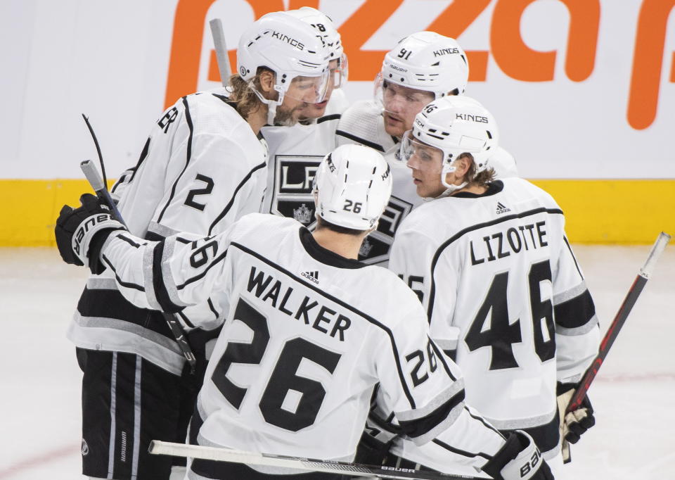 Los Angeles Kings' Alexander Edler (2) celebrates with teammates after scoring against the Montreal Canadiens during third-period NHL hockey game action in Montreal, Saturday, Dec. 10, 2022. (Graham Hughes/The Canadian Press via AP)