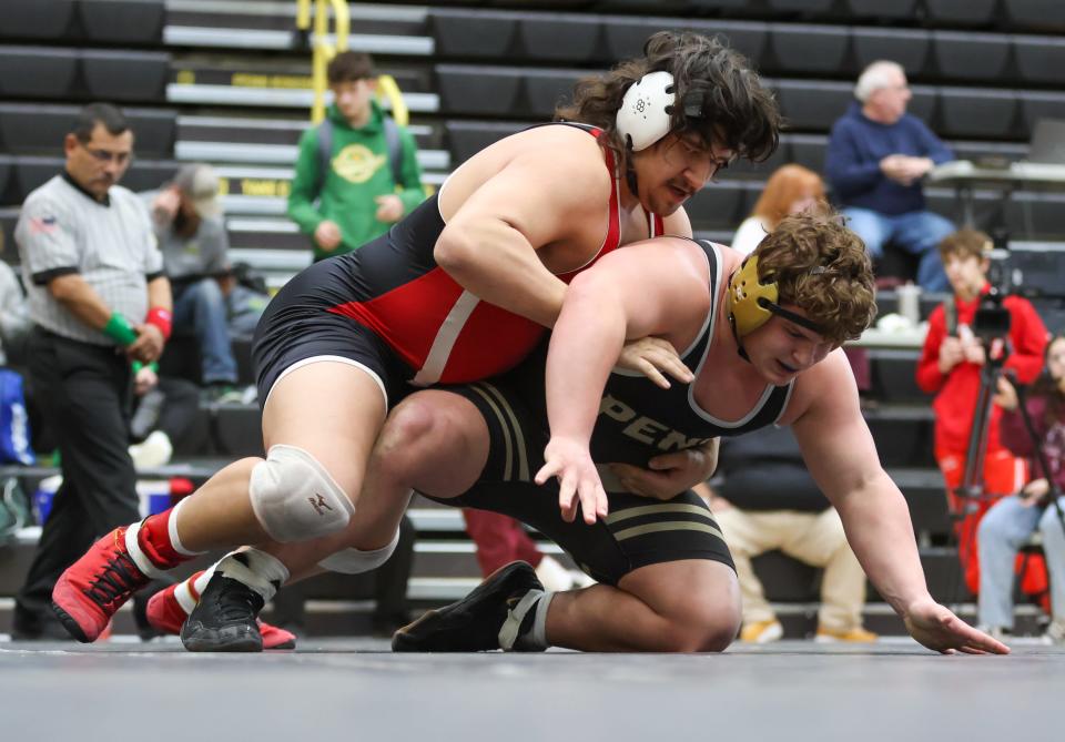 Anthony Popi of Plymouth wrestles Peyton Kendall of Penn in the final at 285lbs during the IHSAA Wrestling Regionals Saturday, Feb. 4, 2023 at Penn High School. Popi won.