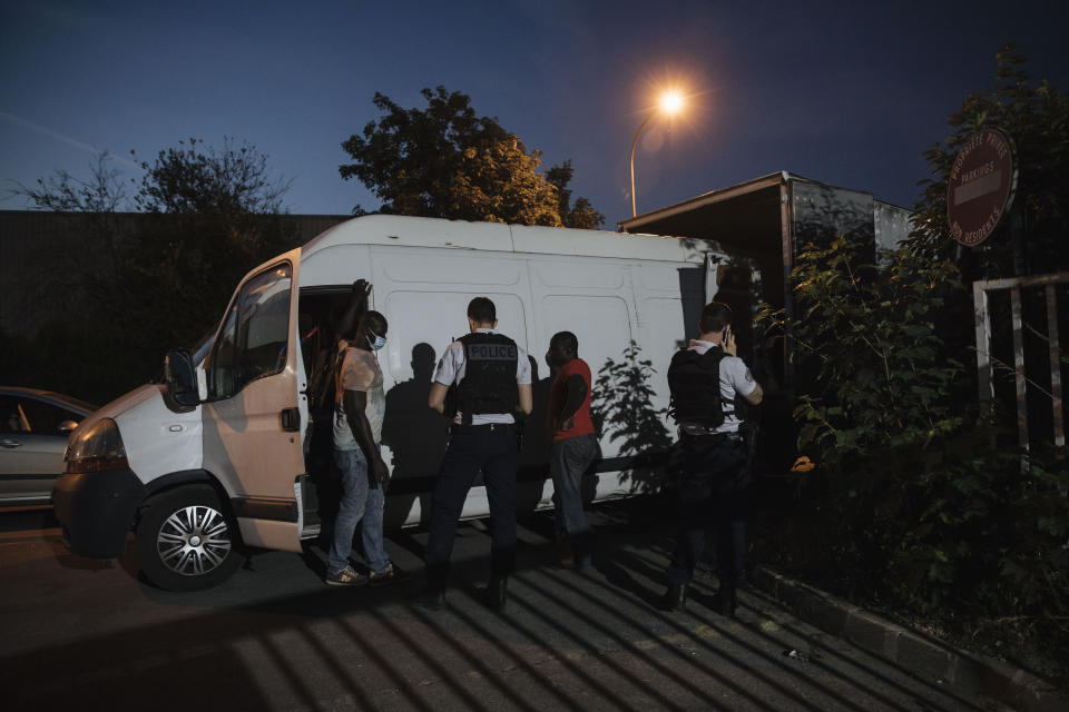 Police officers check people driving a van in the Paris suburb of Sarcelles, Tuesday, June, 15, 2021. In the run-up to France's presidential elections in 2022, crime and policing are again becoming hot-button issues. Some political opponents of President Emmanuel Macron argue that France is becoming an increasingly violent country. (AP Photo/Lewis Joly)