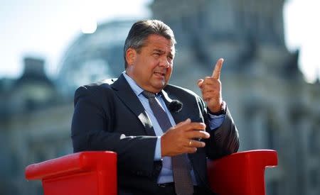 German Economy Minister Sigmar Gabriel arrives for a television interview in front of the Reichstag building in Berlin, Germany, August 7, 2016. REUTERS/Hannibal Hanschke/Files