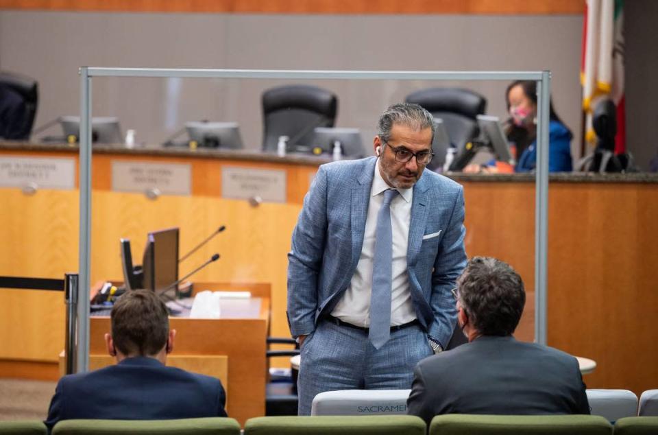 City Councilman Sean Loloee talks with city staff before the Sacramento City Council meeting at City Hall on Tuesday, the first meeting back open to public attendance since the beginning of the COVID-19 pandemic.