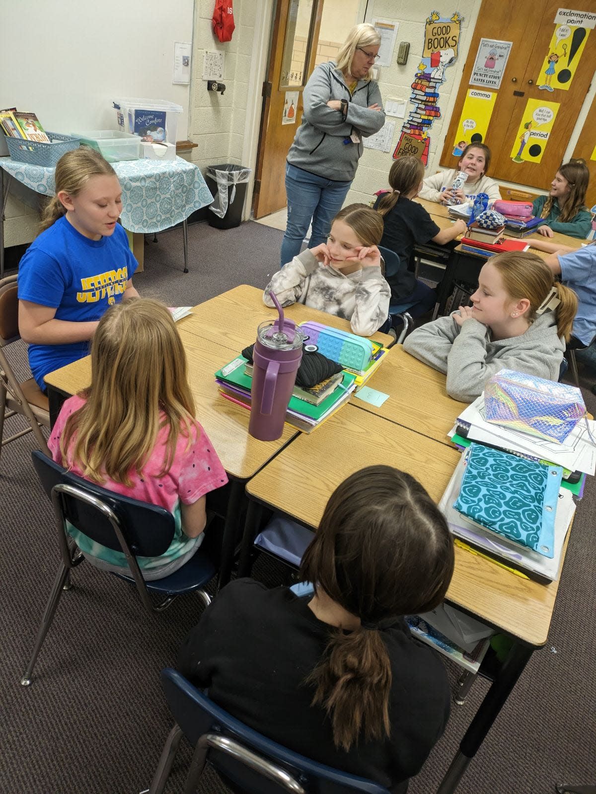 Jefferson Middle School seventh grader Sierra Powers, left, shares her book on ancient China with students in Anita Passon’s fifth grade class.