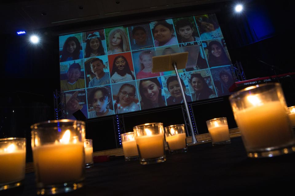 Candles shine as photos of the Uvalde shooting victims rise on a screen behind at Solid Rock Church during a vigil on Tuesday, May 31, 2022. Members of the community attended the NAACP event to mourn the lives lost in Buffalo and Uvalde and call for action.