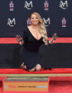 <p>The Grammy winner got dirty as she was honored with a Hand and Footprint Ceremony at TCL Chinese Theatre in Hollywood on Wednesday. (Photo: Neilson Barnard/Getty Images) </p>