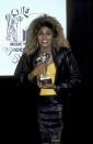 <p>Tina Turner wore a black leather jacket, matching skirt, and yellow top while accepting an award at the 1986 VMAs.</p>