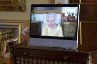 Queen Elizabeth II appears on a screen via videolink from Windsor Castle, where she is in residence, during a virtual audience at Buckingham Palace, London, Oct. 26, 2021. (Victoria Jones/Pool via AP)
