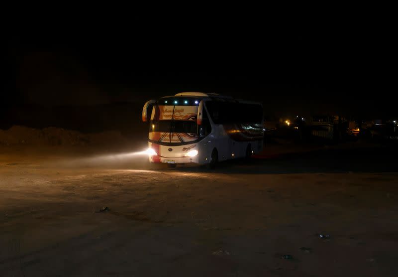 A bus drives from a ferry carrying people fled during the last crisis in Sudan's capital Khartoum, at the upper reaches of the Nile in Aswan