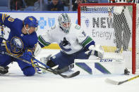 Buffalo Sabres forward Cody Eakin (20) is stopped by Vancouver Canucks goalie Thatcher Demko (35) during the first period of an NHL hockey game Tuesday, Oct. 19, 2021, in Buffalo, N.Y. (AP Photo/Jeffrey T. Barnes)