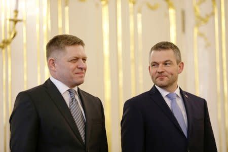 Outgoing Slovak Prime Minister Robert Fico and his successor Peter Pellegrini are seen during the ceremony of tendering resignation by Fico and appointing Pellegrini for the post, at the Presidential Palace in Bratislava, Slovakia, March 15, 2018. REUTERS/David W. Cerny