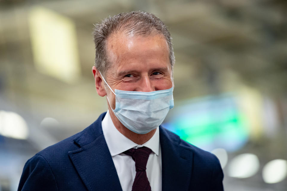 WOLFSBURG, GERMANY - APRIL 27: Herbert Diess, Chairman of the Board of Management of Volkswagen AG wearing a face mask visits the production line at the Wolfsburg Plant on April 27, 2020 in Wolfsburg, Germany. Production was shut down in March due to both to lockdown measures designed to stem the spread of the virus and the breakdown of international supply chains. Germany is taking steps to lift lockdown measures in a careful attempt to get the economy back into gear. (Photo by Swen Pförtner - PoolGetty Images)