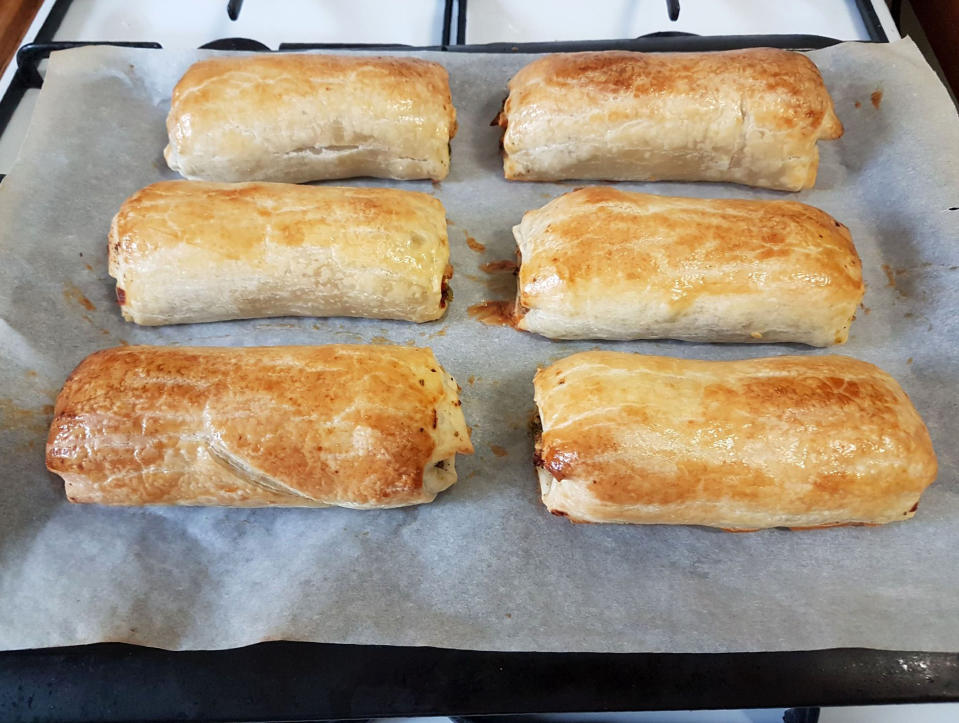 In this May 23, 2020 photo provided by Rick Everett, a tray of freshly baked vegetarian sausage rolls is prepared for friends and neighbors in Sydney, Australia. When the Australian acrobat lost his job in March due to the coronavirus pandemic, Everett decided to use his newfound free time to help others in need. (Rick Everett via AP)