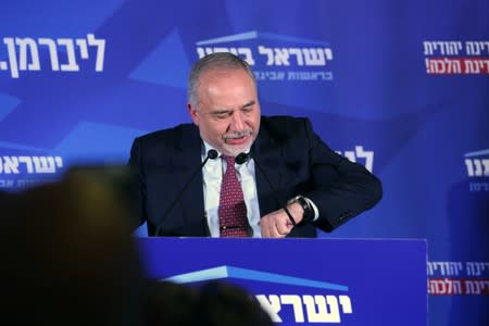 Avigdor Lieberman, leader of Yisrael Beitenu party looks at his watch as he speaks following the announcement of exit polls in Israel's parliamentary election at his party headquarters in Jerusalem