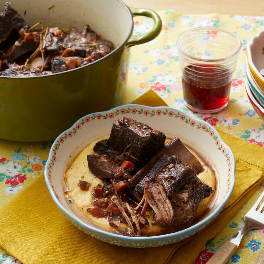 braised short ribs in bowl over polenta with red wine