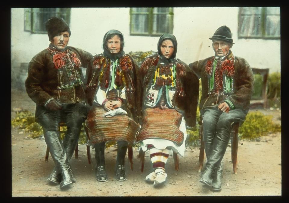 In an undated photograph, two Hutsul men and two Hutsul women in traditional clothes sit together on a bench in Carpatho-Ukraine. (Jar. Novotny/Scheufler Collection/Corbis/VCG via Getty Images)