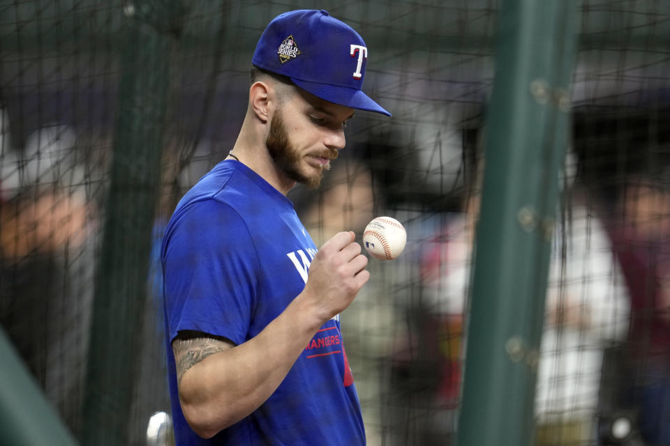 Texas Rangers catcher Jonah Heim tosses a ball during batting practice before Game 2 of the baseball World Series against the Arizona Diamondbacks Saturday, Oct. 28, 2023, in Arlington, Texas. (AP Photo/Godofredo A. Vásquez)