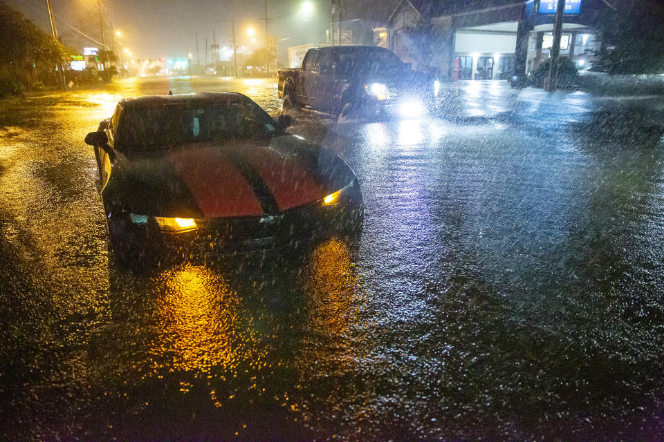 Motorists navigate a flooded Gause Boulevard in Slidell, La., late Friday, June 18, 2021, as a tropical disturbance neared the Louisiana shore. Tropical Storm Claudette has formed Saturday morning along the U.S. Gulf Coast, bringing heavy rains and flooding to coastal states including Louisiana, Mississippi and Alabama. (Scott Threlkeld/The Advocate via AP)