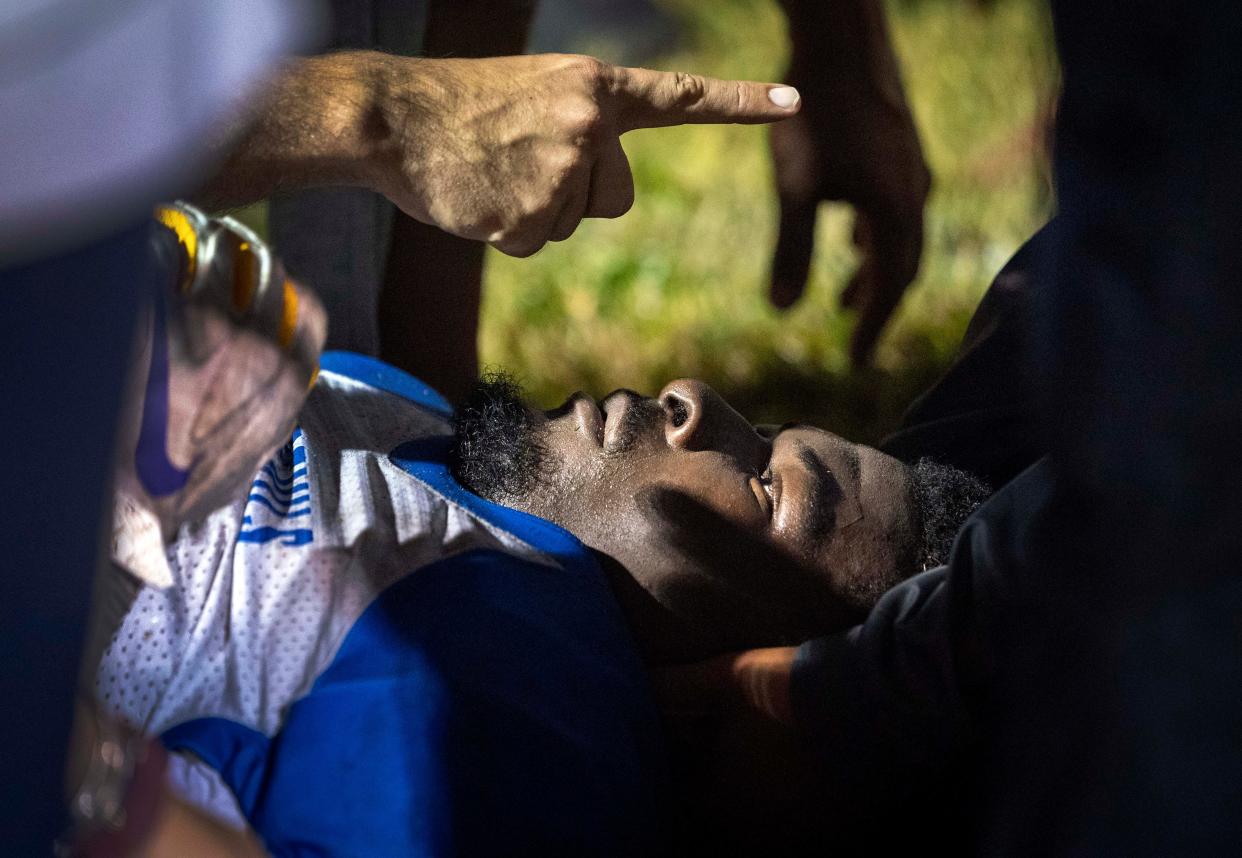 Medical personnel attend to Pahokee to Pierre Fertil after he was injured against Dwyer in Palm Beach Gardens, Florida on September 29, 2023.