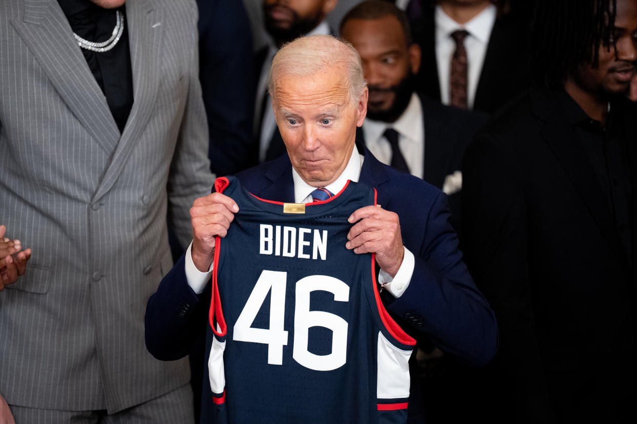 WASHINGTON, DC - SEPTEMBER 10: U.S. President Joe Biden reacts as he is given a team jersey during a celebration of the 2023-2024 University of Connecticut Huskies Men's Basketball NCAA championship team in the East Room of the White House on September 10, 2024 in Washington, DC. The Huskies beat the Purdue Boilermakers 75-60 for their sixth NCAA Championship and their second championship in a row. (Photo by Andrew Harnik/Getty Images)