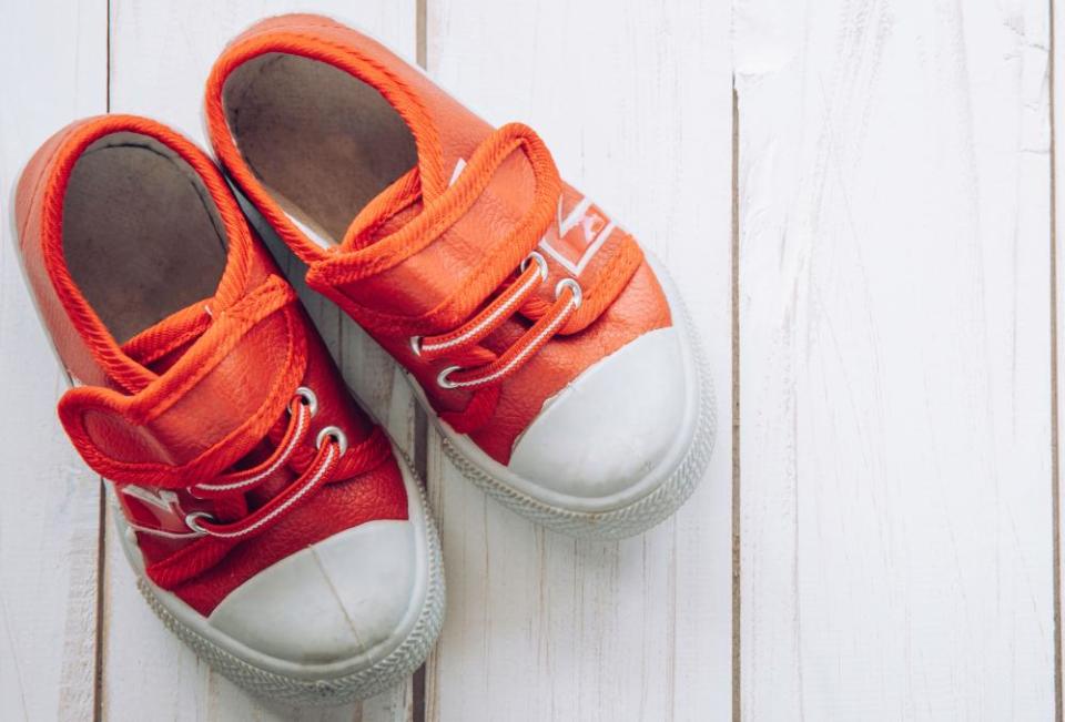 Red shoes for children on wooden floor