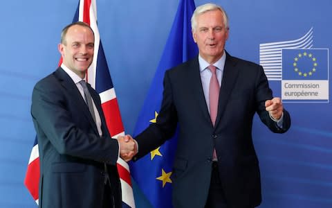 Dominic Raab, left, is welcomed by EU's chief Brexit negotiator Michel Barnier  - Credit: EPA