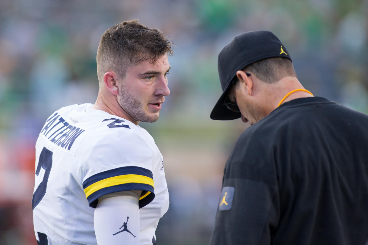 Is Michigan quarterback Shea Patterson's job on the line with head coach Jim Harbaugh? (Getty Images)