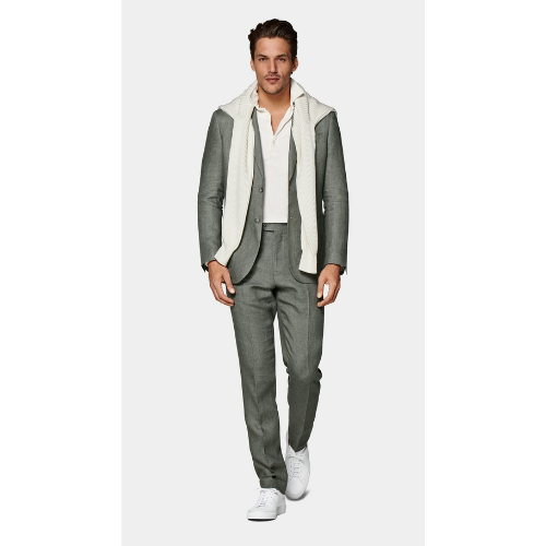 man wearing ligh gray SuitSupply suit against white background