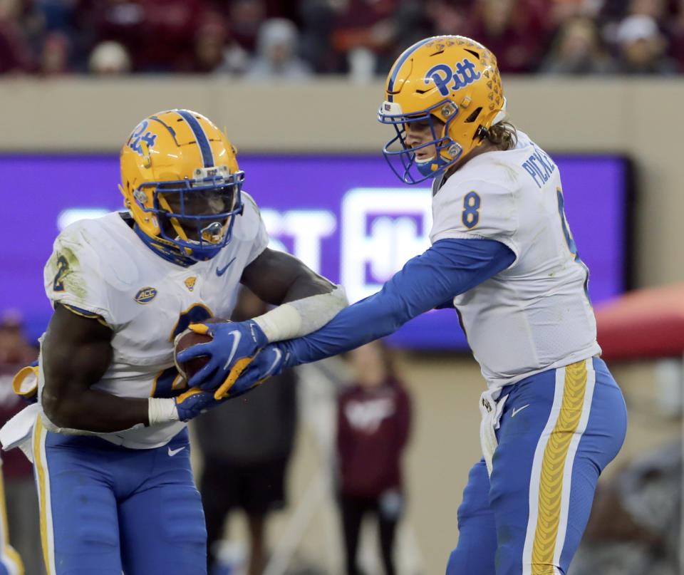 Pittsburgh quarterback Kenny Pickett (8) hands off to Pittsburgh's Israel Abanikanda (2) in the second half of an NCAA college football game against Virginia Tech, Saturday, Oct. 16, 2021, in Blacksburg, Va. (Matt Gentry/The Roanoke Times via AP)